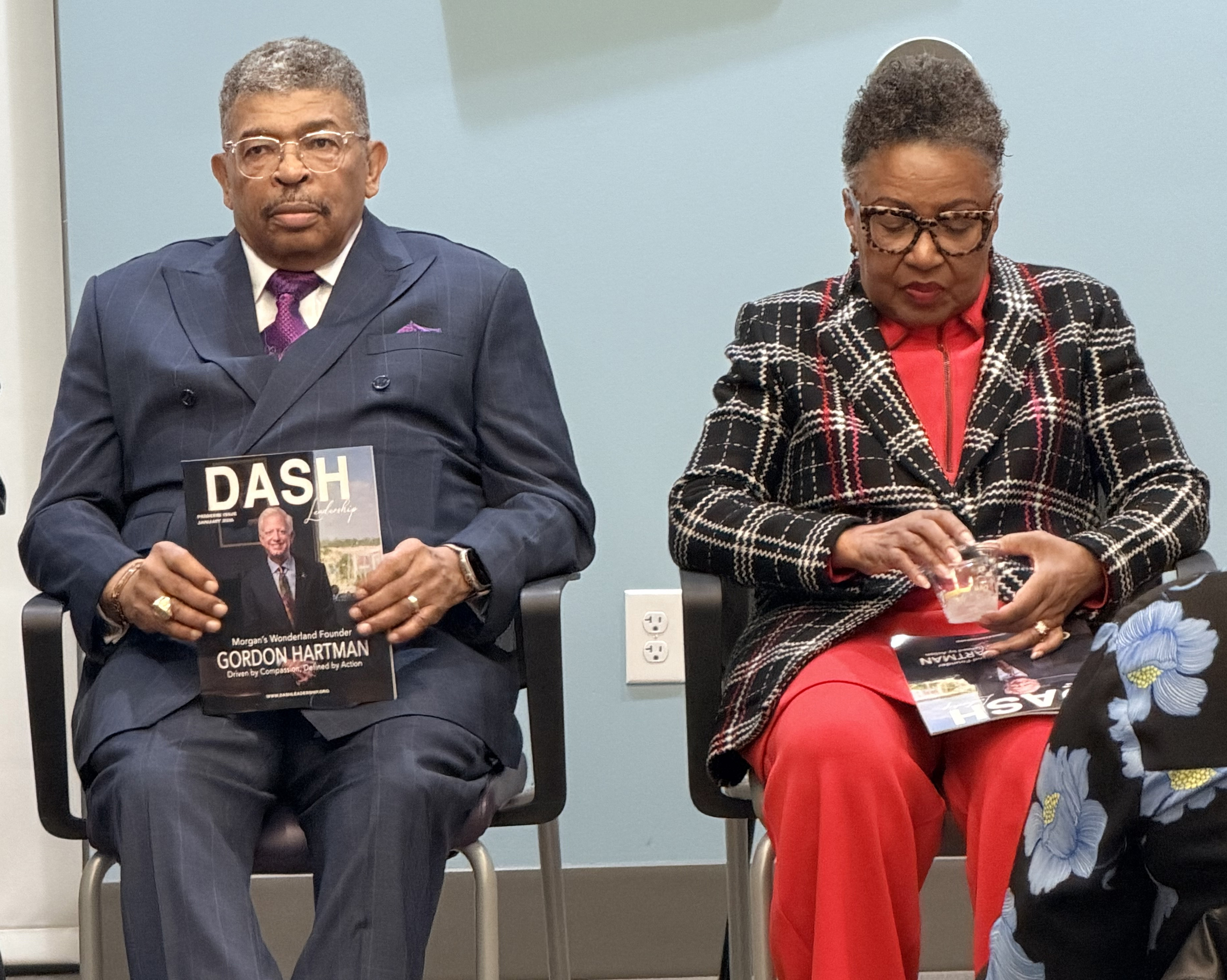 Guests seated at the DASH Leadership magazine launch, one holding the premiere issue featuring Gordon Hartman