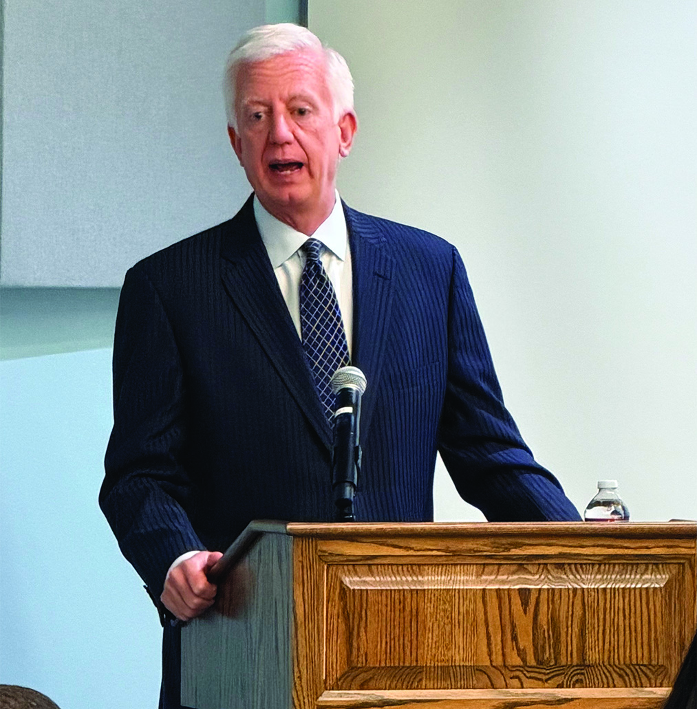 Speaker addressing guests at the podium during a DASH Leadership event